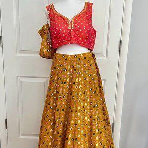 Orange and gold embroidered lehenga set with mirror work